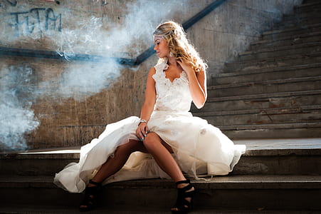 woman wearing white dress sitting on stair case