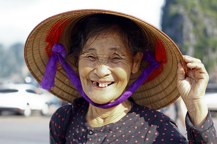 woman wearing brown wicker hat showing smile