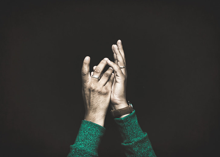 person's hand with black background