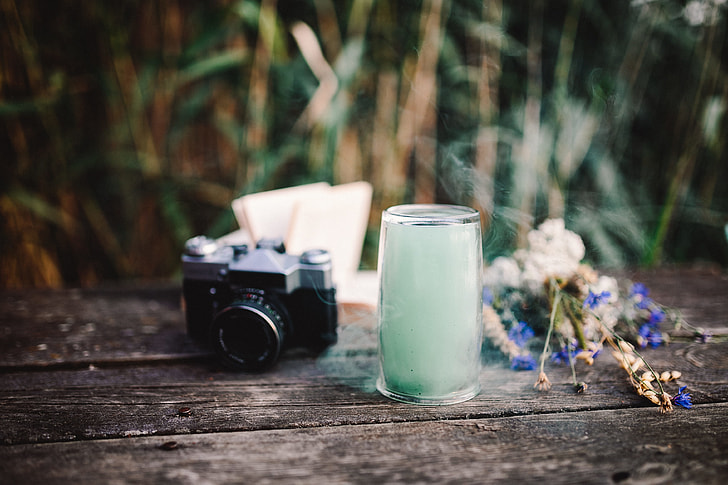 Colorful smoke bomb, book and vintage camera