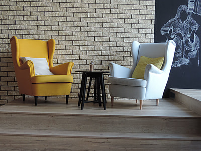 two white and yellow wingback chairs