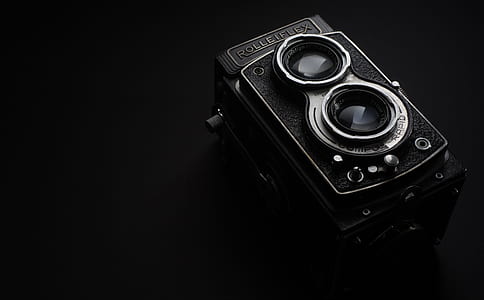 black and gray camera with black background
