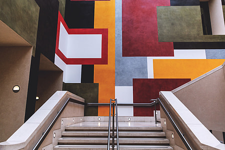 Staircase interior leading up to vibrant wall art in a building in London