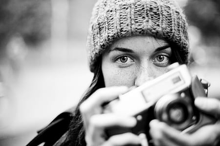 woman holding black camera