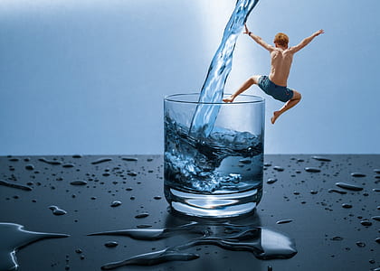 man jumping on clear rock glass filled of water i