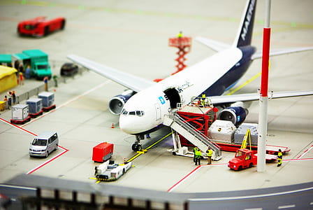 white and black Airliner scale model with car die-cast