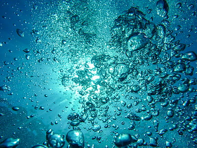 underwater photography of bubbles