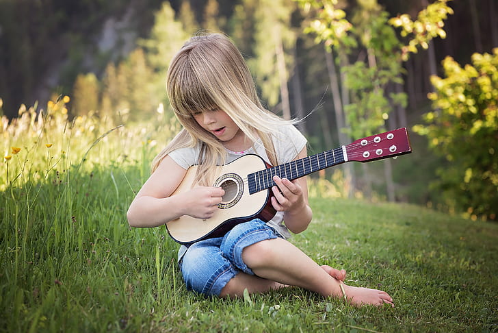 girl playing of beige guitar