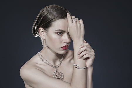 topless woman with silver-colored necklace and red lip tint