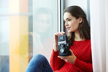 Woman Wearing Red Knitted Shirt Holding Instant Camera