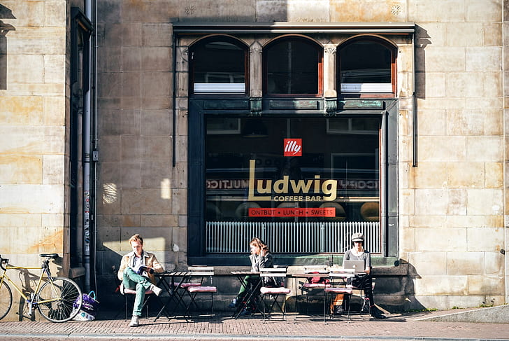 photo of three people sitting in front of Ludwig coffee