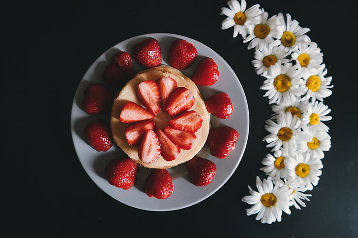 Overhead shot of strawberries and flowers