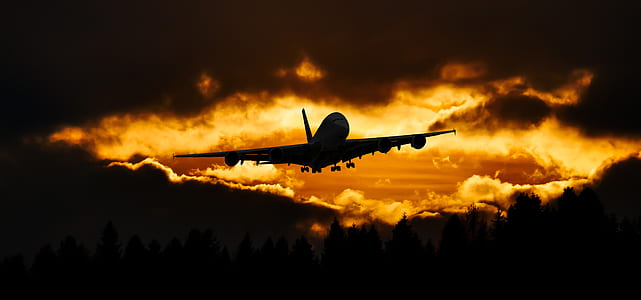 silhouette of airplane during sunset