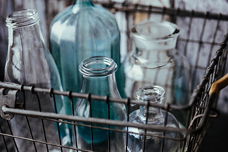 Collection of bottles in metal mesh basket