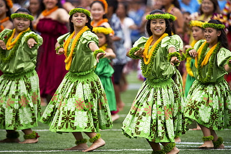 group of women in green floral dress dancing