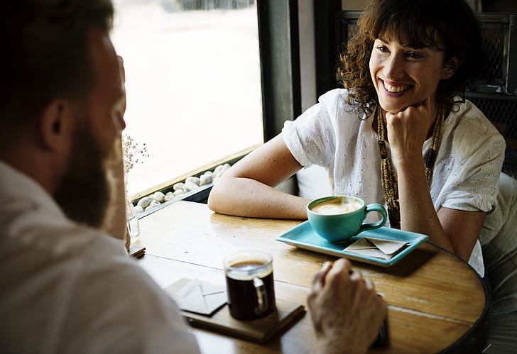 man and woman dating while smiling at eachother