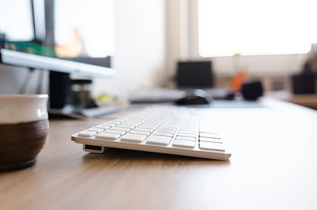 Apple Magic Keyboard on brown surface