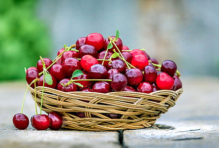 red cherry on brown wicker basket