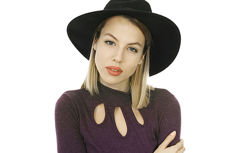 woman wearing black hat and maroon crew-neck top