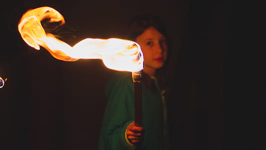 girl holding torch during nighttime