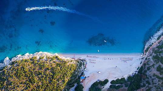 aerial photography of beach near the mountains