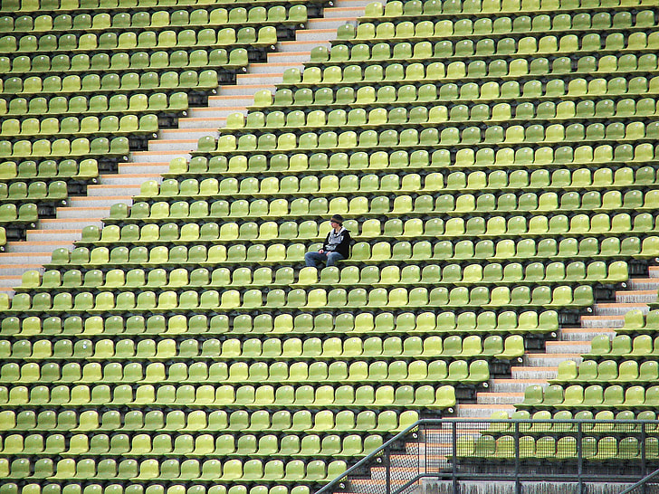person sitting alone in green gang chair