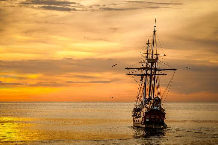 Brown Sailing Boat on the Sea during Sunset