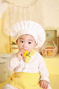 selective focus photography of boy in chef costume
