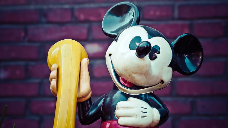 Mickey Mouse holding yellow telephone