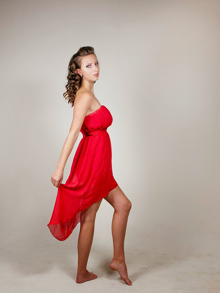 woman in red strapless high-low dress
