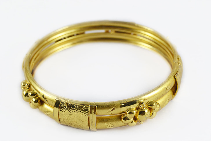 gold-colored floral bangle