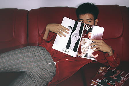 Photography of a Man Holding Magazine