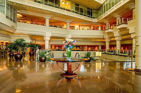 photo of flower vase on top of round glass-top table near escalator