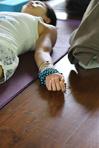 woman lying on purple yoga mat