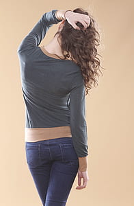 woman in gray long-sleeved shirt with blue denim jeans