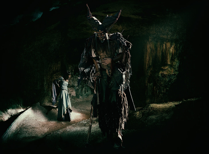 horned male character walking near woman in gray dress wallpaper