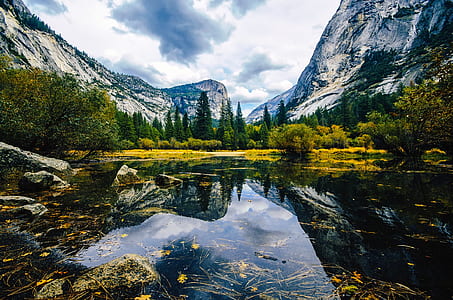 landscape photography of body of water near mountains