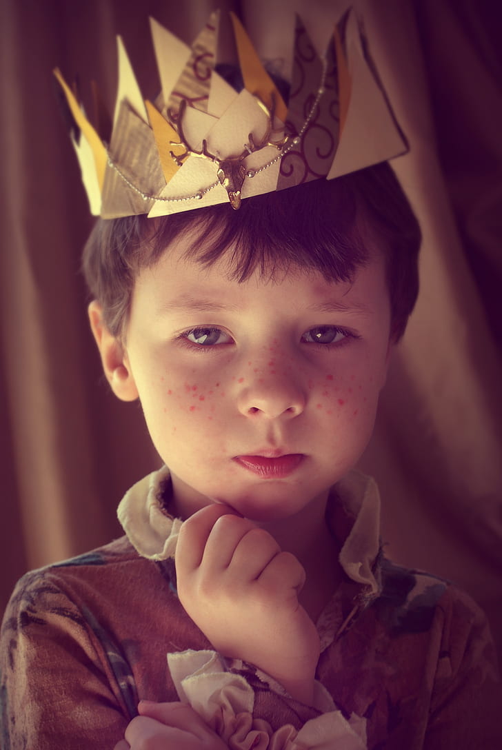 boy in brown collared ruffled top with crown portrait photo