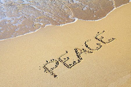 brown sand written with peace text