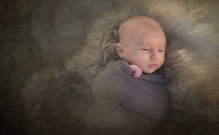 baby sleeping in brown fur textile