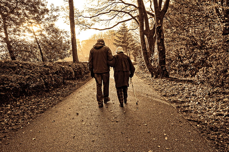 couple walking along concrete pathway