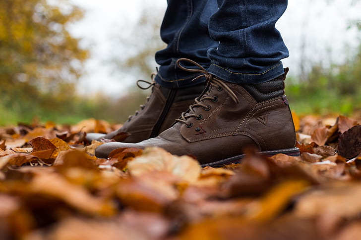shallow focus photography of a man wearing a pair of brown shoes
