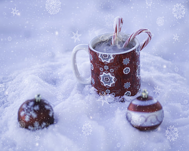 closeup photo of mug and baubles on white surface