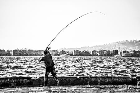 Royalty-Free photo: Shallow focus photography of a person holding brown fishing rod - PickPik