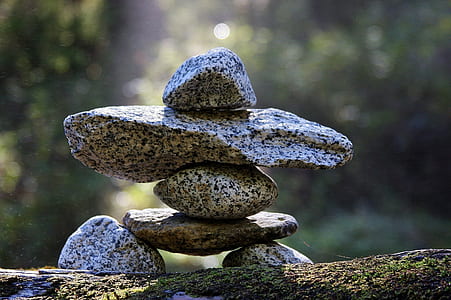 depth of field photography of gray balancing stone