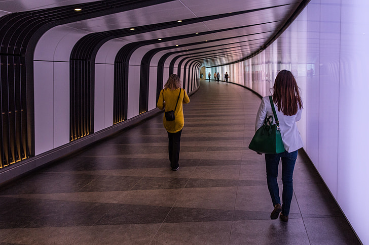 People walking down a futuristic light-wall tunnel at King’s Cross, London. This image was captured with a Canon 6D DSLR