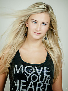 woman wearing black scoop-neck sleeveless tops with move your heart text