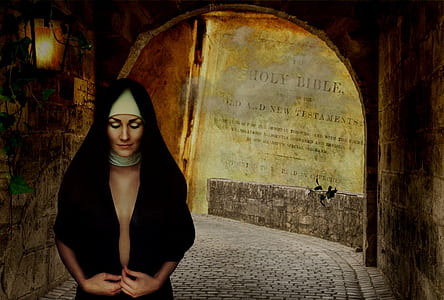 woman wearing black headdress standing inside tunnel