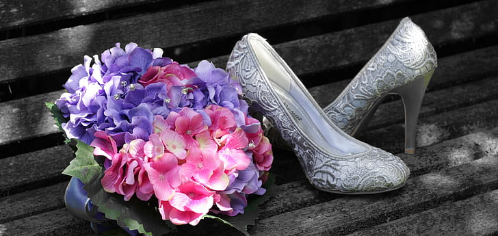 pair of silver shoes and bouquet of flowers