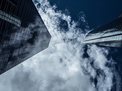 low angle photograph of building and clouds